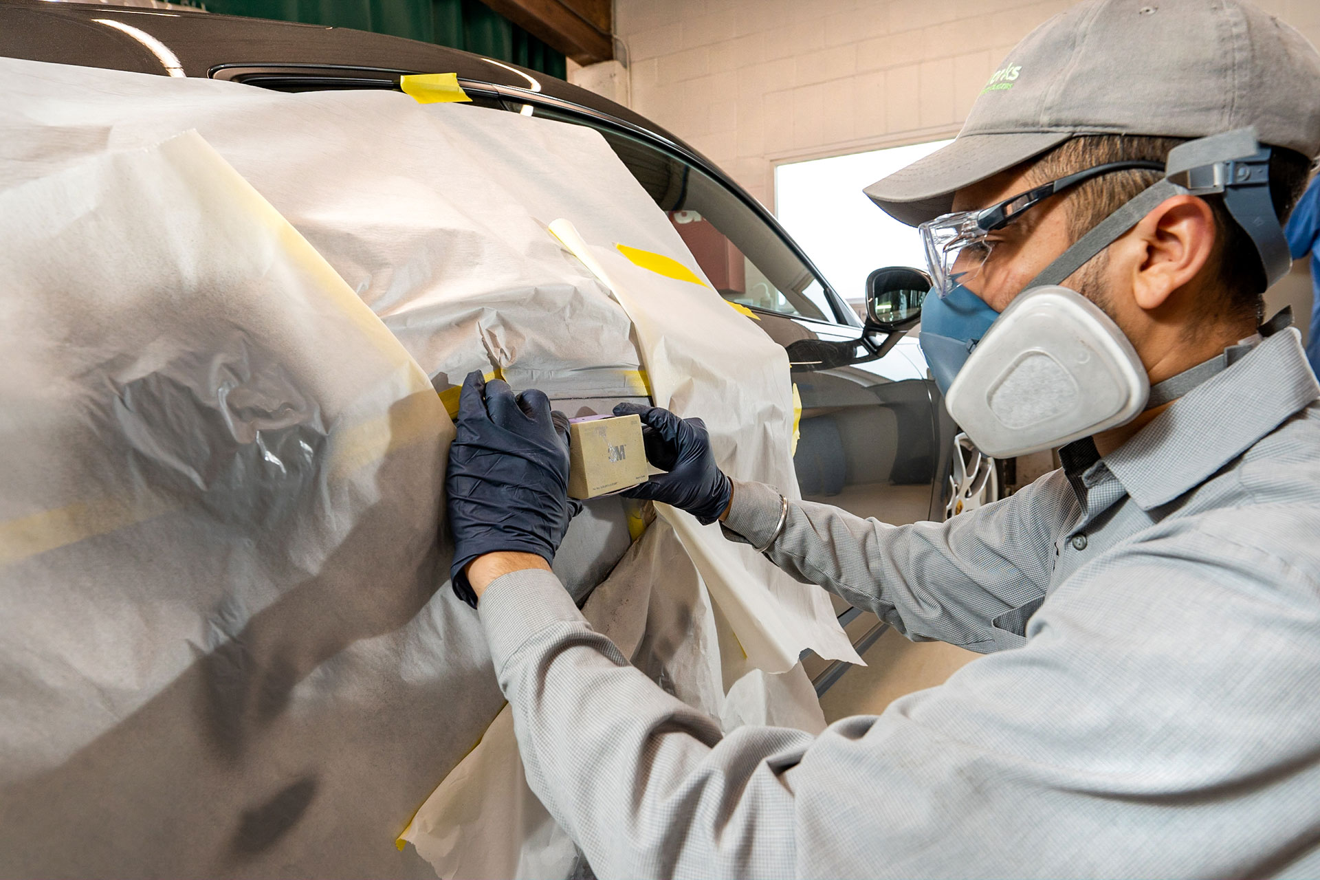 Close-up of SMART paint repair being done on a car at Colorworks.
