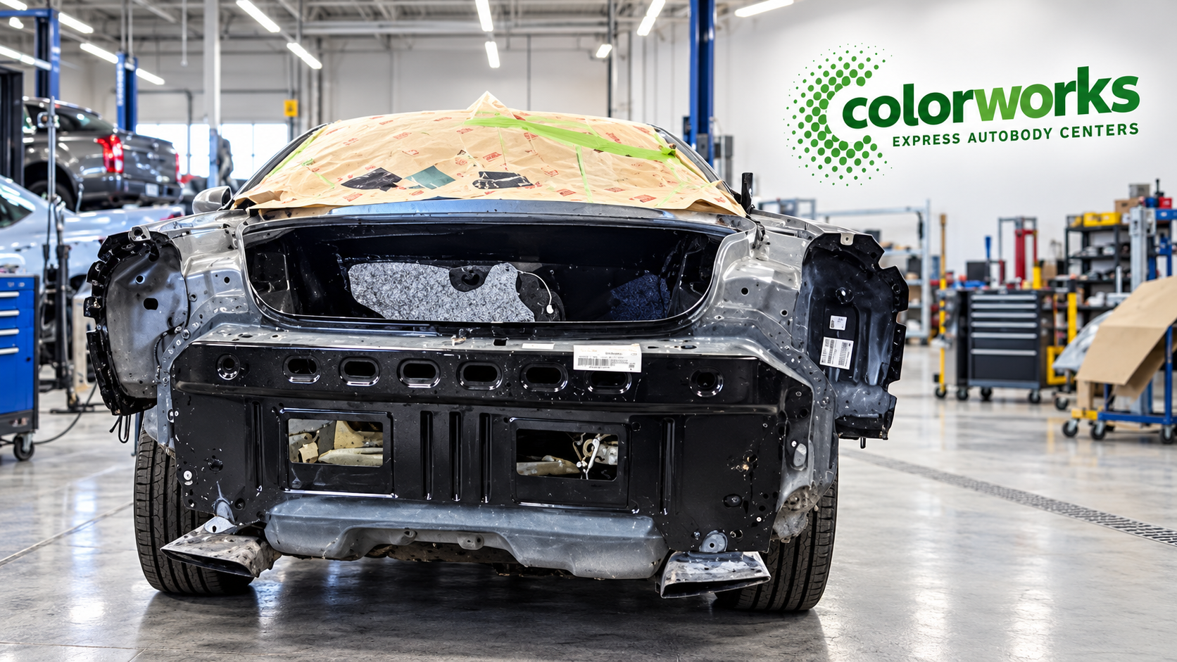 Dodge car undergoing collision repairs with Colorworks Express branding
