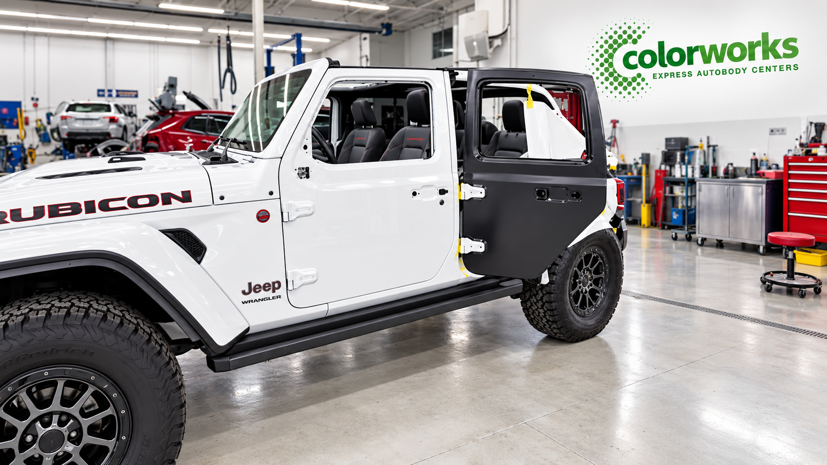 White Jeep Wrangler Rubicon in a repair workshop with Colorworks Express branding