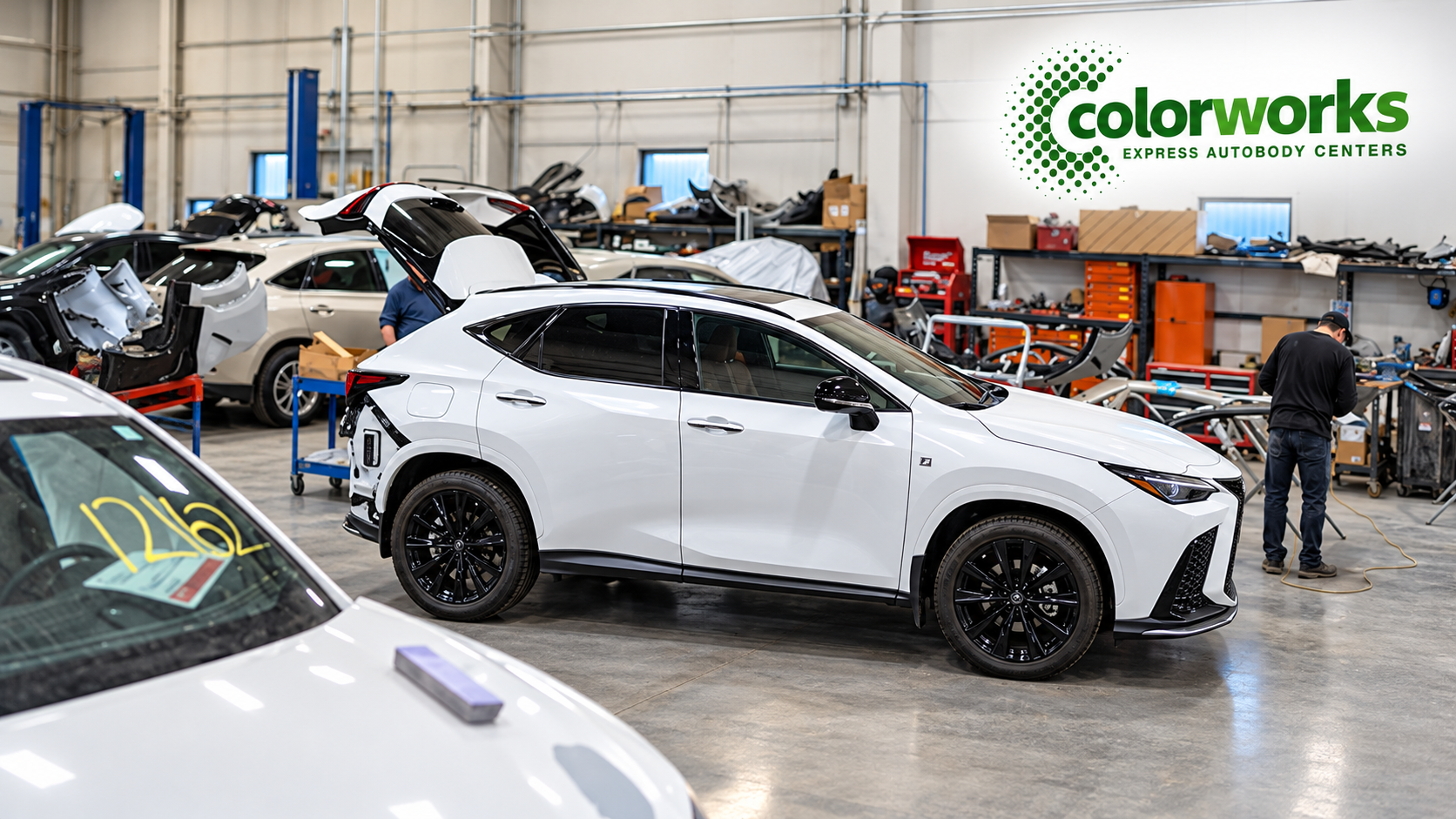 White Lexus SUV in an auto body repair shop with Colorworks Express branding