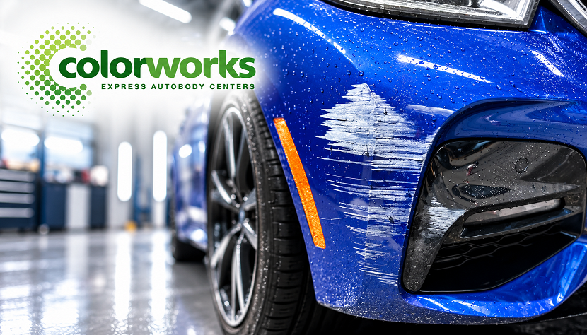 Paint scuffs and scratches on a blue car bumper with Colorworks Express branding